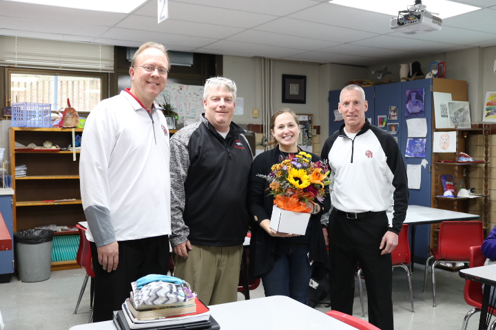 DMS teacher Mary Sala presented with flowers for being named the Outstanding Art Teacher for 2019
